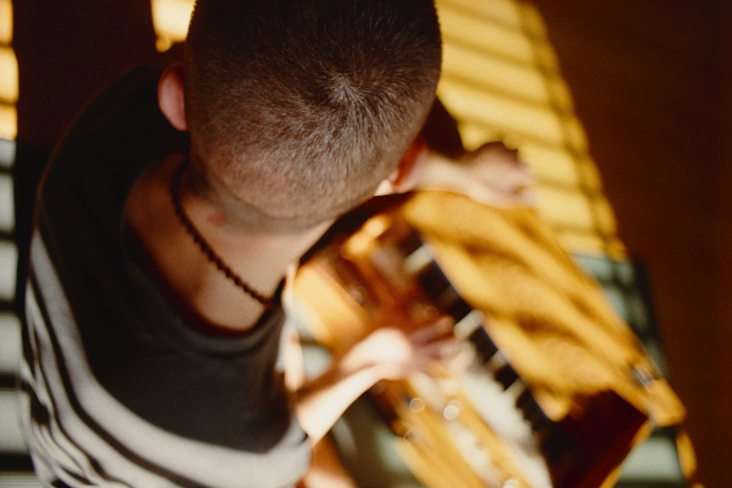 Close overhead frame of hands playing a harmonium in warm light